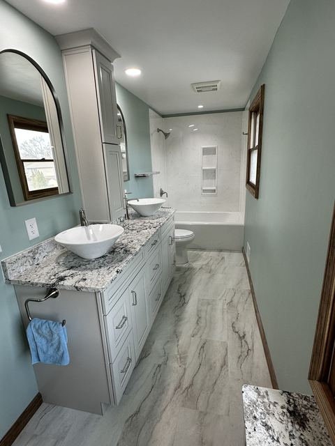 Bathroom with granite-top double vanity and vessel sinks
