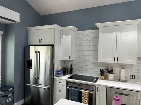 Kitchen with white shaker cabinets and stainless appliances