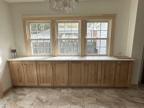 Custom maple built-in cabinets with tile floor
